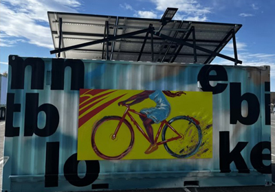 LinkGridPhotos-CHFAGolfImagery2025-BeneficiaryPhoto2-400x280.jpg a poster of a person riding a bike on a metal wall