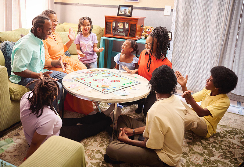  A family around a living room table playing games