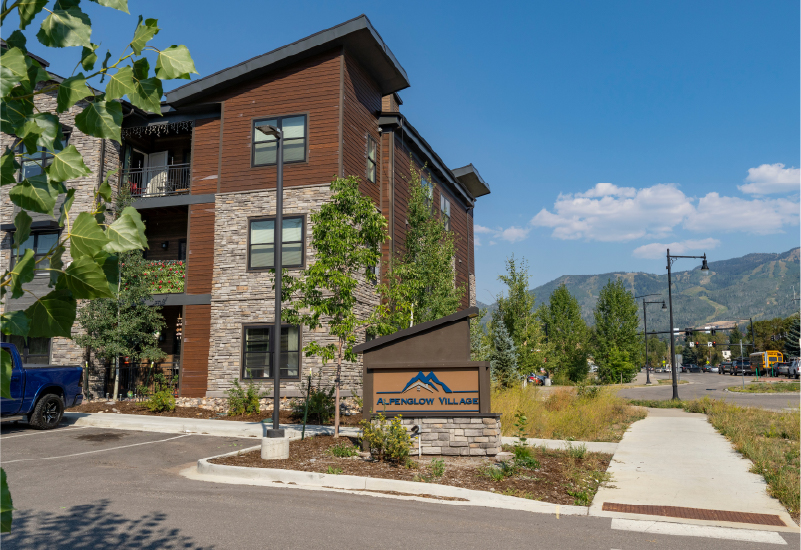 An exterior photo of Alpenglow Village with its sign