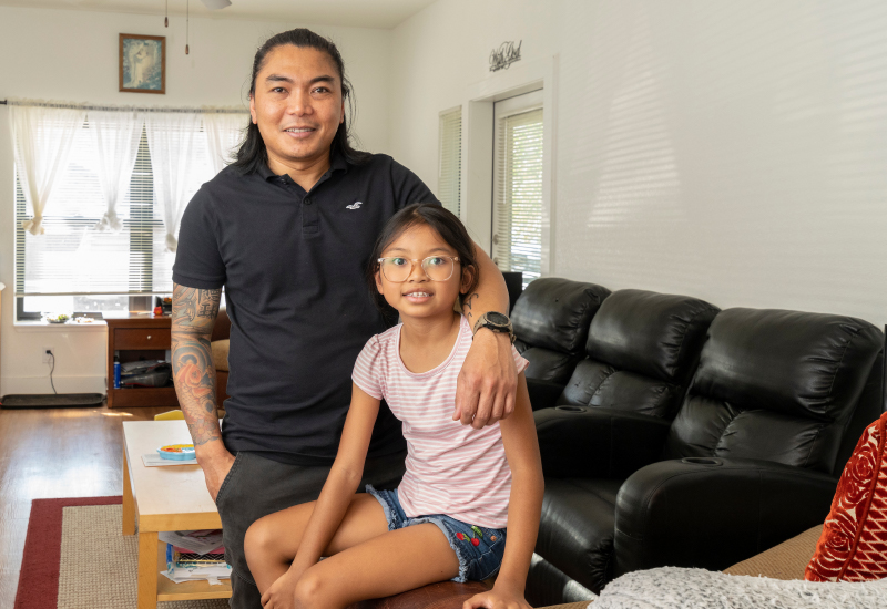 A parent and child inside a living room