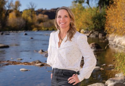 Kimball Crangle standing next to a river and fall trees