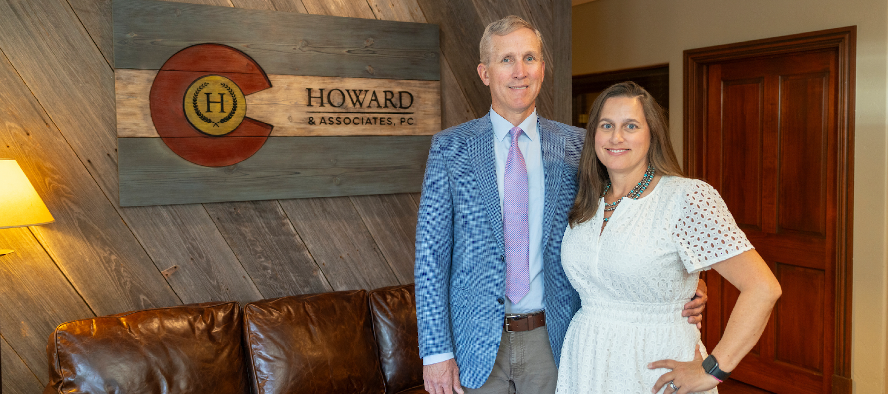 Staff members standing in the offices of Howard and Associates