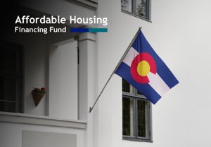 A Colorado flag on a multifamily building and text that reads Affordable Housing Financing Fund